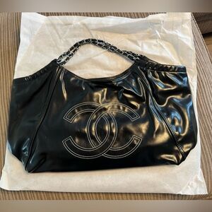 Black knock off ‘Chanel’ bag. blank exterior brown liner with Chanel fabric.